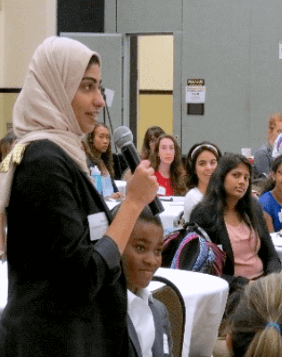 Female asking an question at a forum