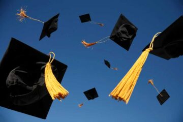 UCF Graduation caps thrown into the air