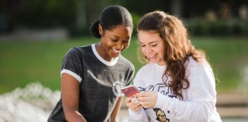 Two students looking at a cellphone